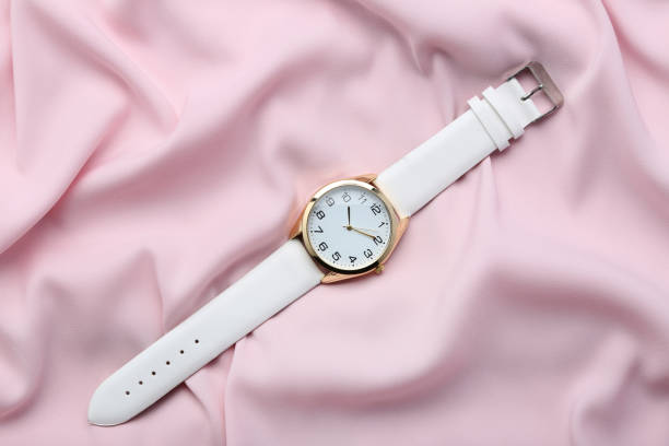 istock Wrist watch on pink satin background 1008287128