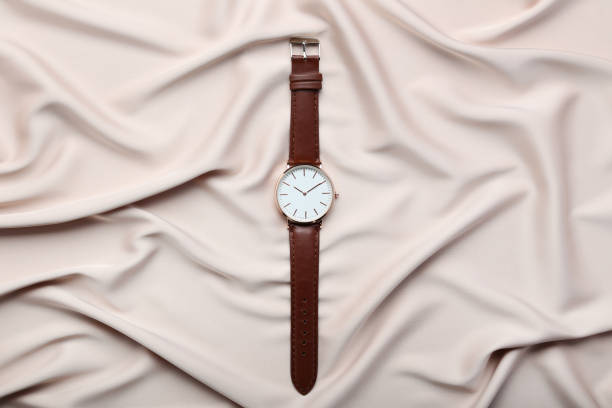 istock Wrist watch on beige satin background 1008287328