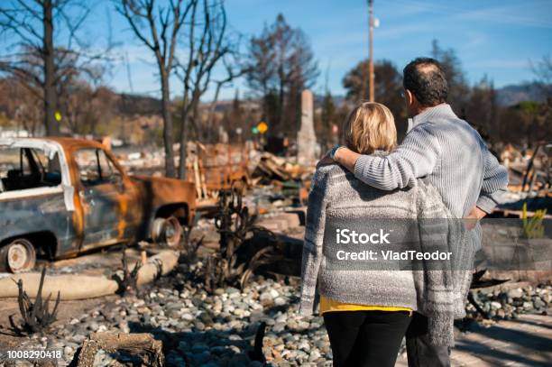 Couple Checking Ruins After Fire Disaster Stock Photo - Download Image Now - Forest Fire, Fire - Natural Phenomenon, House