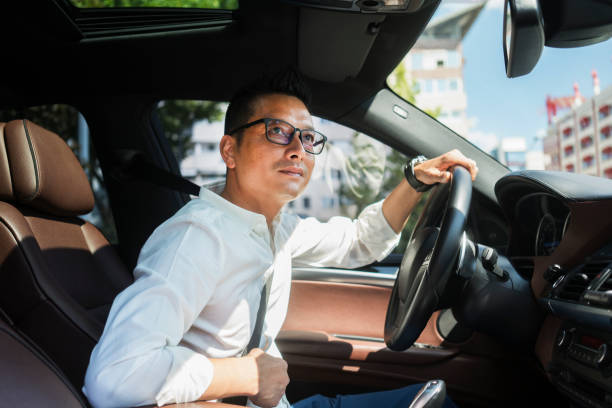 istock Chinese businessman draving a car 1008290642