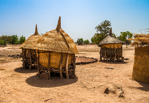 Traditional granaries made of woods and straw in an african village in Burkina Faso. They are on stilts to protect the crops against animals.