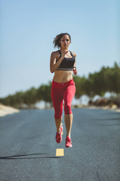 istock Female jogger running on asphalt 1008308144