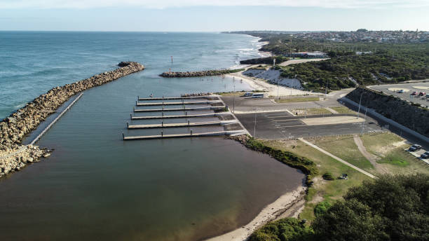 istock Aerial view Ocean Reef  boat harbour Perth Western Australia seaside coast waves rolling onto shore and stand up paddle boarders behind sea wall 1008313278