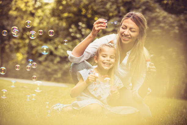 istock Bubbles game. Mother and daughter at nature. 1008316282