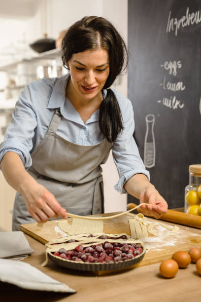 istock Woman preparingsweet pie in her kitchen 1008330276