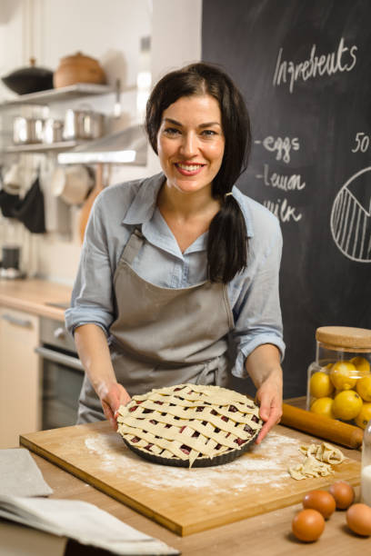 istock Woman preparingsweet pie in her kitchen 1008330386