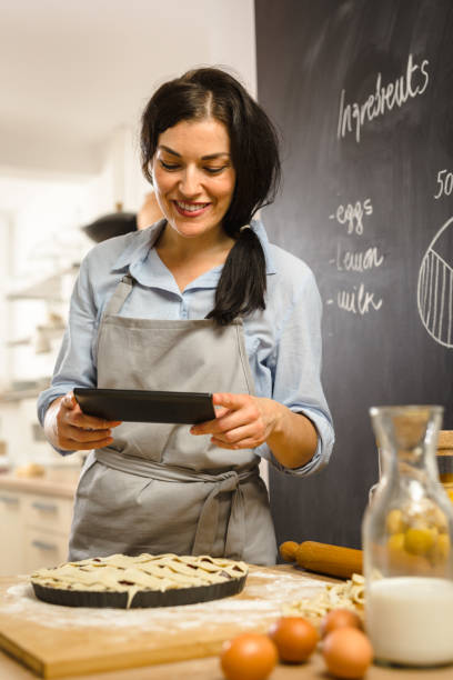 Woman preparingsweet pie in her kitchen