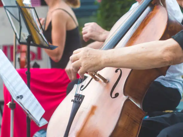 Photo of close up street musician playing violin instrument jazz music performer