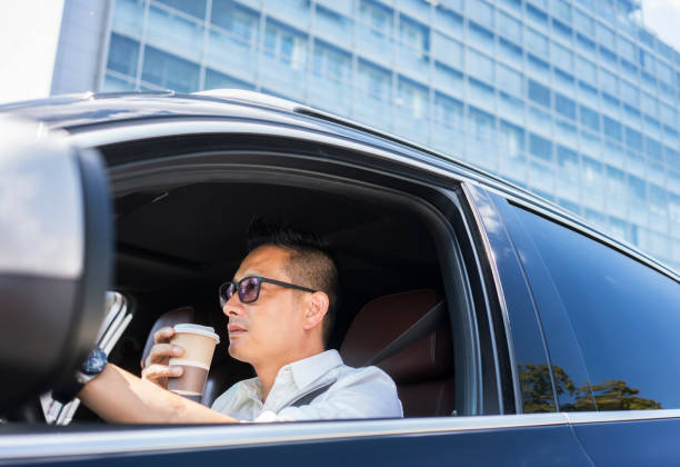 istock Chinese businessman draving a car 1008336384