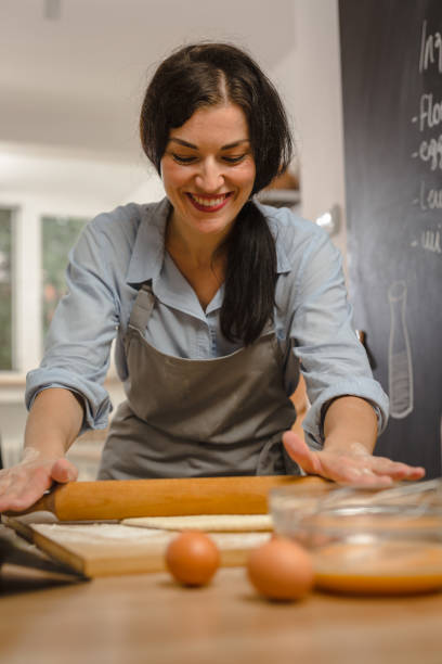 istock Woman preparingsweet pie in her kitchen 1008336576