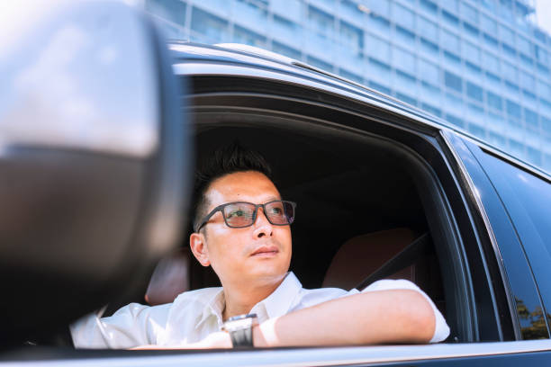 istock Chinese businessman draving a car 1008336608