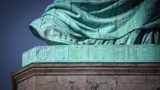 The size 879 foot of the Statue of Liberty rising off its pedestal.