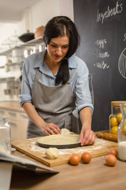 istock Woman preparingsweet pie in her kitchen 1008341194
