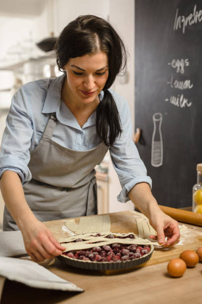 istock Woman preparingsweet pie in her kitchen 1008341258