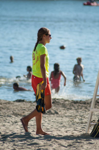 lifeguard walking near chair in front of the lake - belfort imagens e fotografias de stock