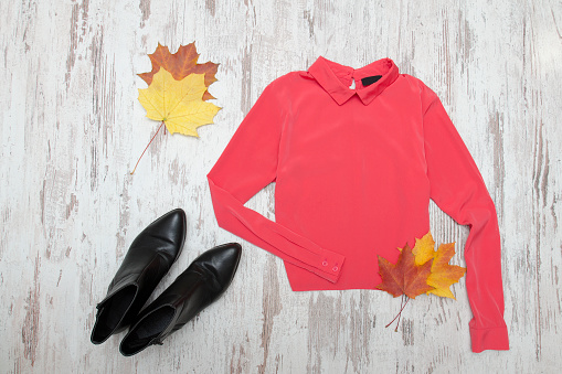 Pink blouse, black shoes and maple leaf. Fashionable concept.