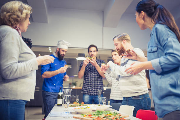 istock Attendees of cooking class celebrating  successful end of class 1008357388