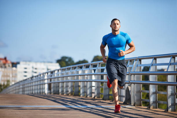 istock Handsome athletic man out jogging in the city 1008357822