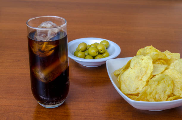 istock traditional Spanish appetizer with olives, potato chips  and cola 1008358148