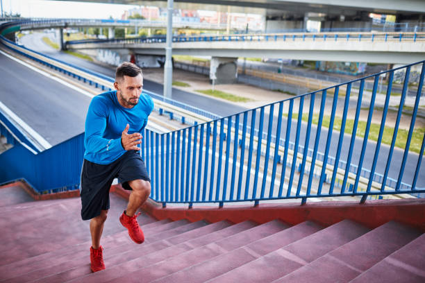 istock Handsome and athletic man jogging up a staircase during an outdoors workout 1008358396