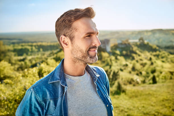 Portrait of smiling man during hiking trip in the mountains stock photo