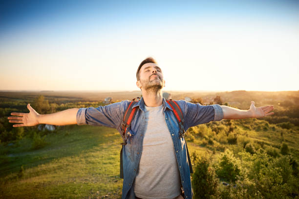 istock Man extending arms in happy gesture while hiking in the mountains 1008363558