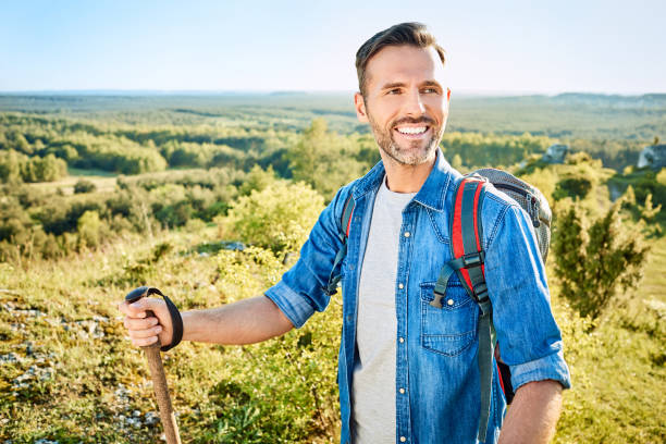 istock Cheerful man hiking and looking away during trip in the mountains 1008363816