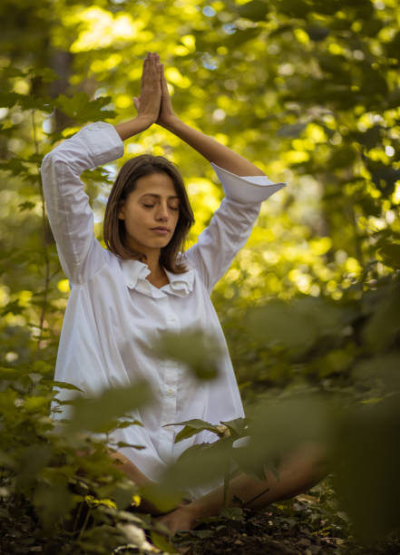 istock Young women in nature exercise yoga. 1008366204