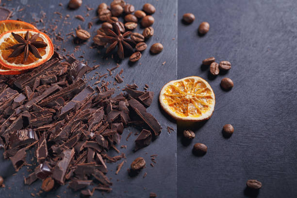 istock Dark chopping chocolate, black roasted coffee beans, dried lemon slices on dark background 1008366354