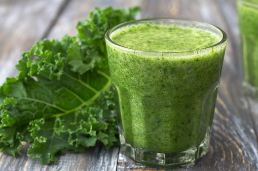 Green smoothies with kale, banana and lemon. on a wooden table. selective focus. healthy diet food