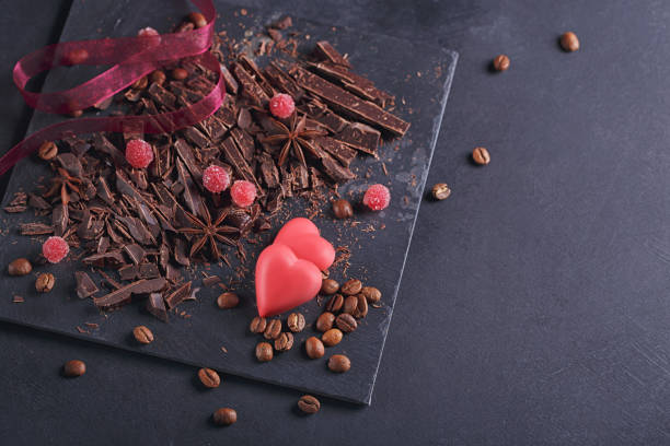 istock Dark chopping chocolate, black roasted coffee beans, dried lemon slices on dark background 1008366364