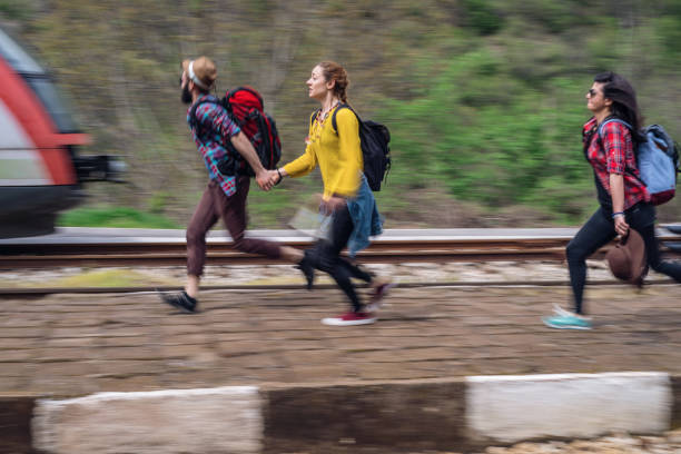 istock Friends running late for the train at the railway platform 1008367150