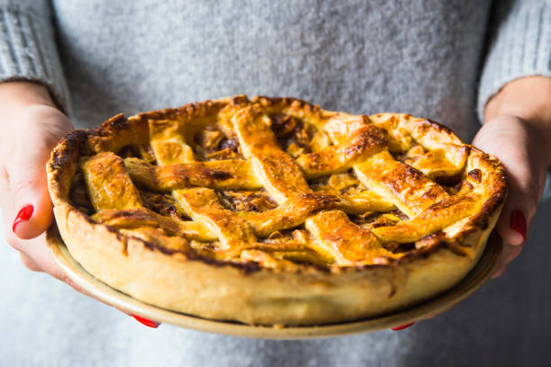 istock Homemade apple pie in female hands. Autumn Baking Concept 1008372582