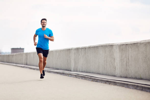 istock Handsome man running outdoors 1008376594