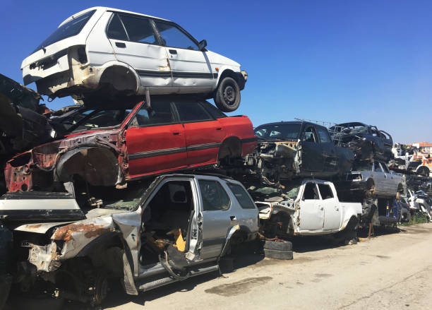 Old damaged cars on the junkyard waiting for recycling stock photo