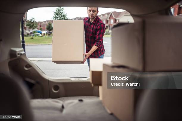 Man Loading Boxes In To His Car Stock Photo - Download Image Now - Car Trunk, Loading, Box - Container