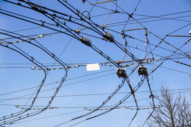 istock Black tram wires over blue sky 1008379692