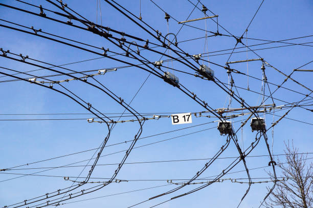 Black tram wires over blue sky