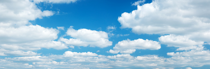 Panoramic skyscape from the horizon of clouds in a blue sky in summer.