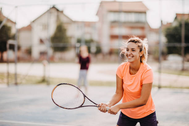 istock Womens doubles match tennis volley 1008402048