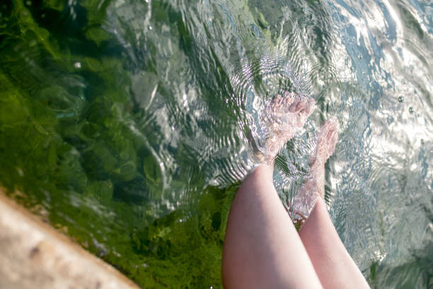 istock Dipping feet in water off a dock on a hot summer day. 1008402442