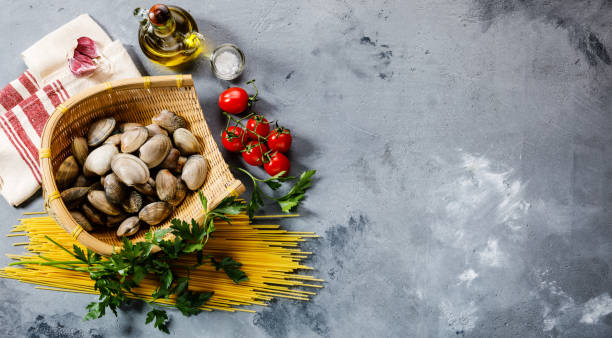 Sauté di vongole also known as a fast stew of clams, garlic and cherry tomatoes in olive oil and white wine served with a nice piece of rustic bread.