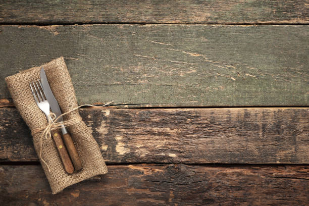 istock Fork and knife with sackcloth on wooden table 1008408506