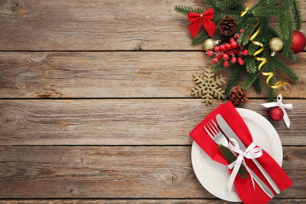 istock Kitchen cutlery with plate and christmas decorations on wooden table 1008409386