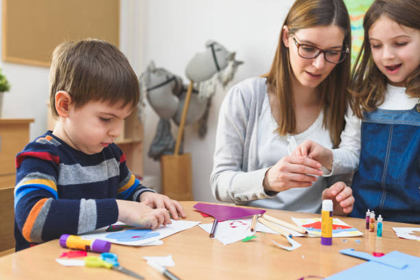 istock Preschool Teacher with Children at Kindergarten - Creative Art Class 1008409496