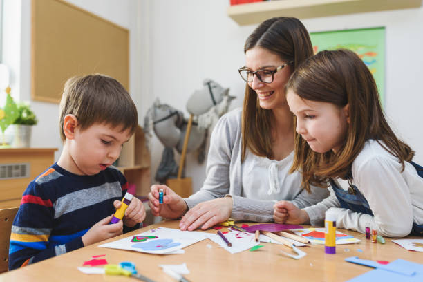 istock Preschool Teacher with Children at Kindergarten - Creative Art Class 1008409512