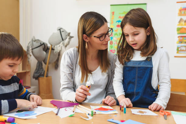 istock Preschool Teacher with Children at Kindergarten - Creative Art Class 1008412810