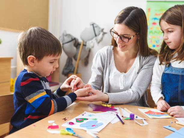 istock Preschool Teacher with Children at Kindergarten - Creative Art Class 1008413012