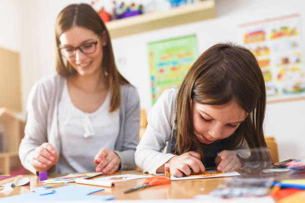 istock Preschool Teacher With Cute Girl - Creative Art Class 1008413190