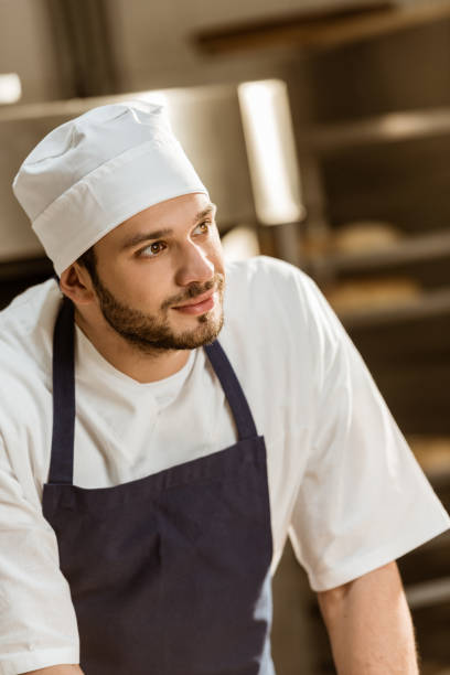istock close-up portrait of handsome young baker on baking manufacture 1008413212